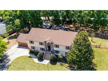 Expansive two-story home featuring a charming brick facade and lush landscaping at 16017 Harbar Oaks Dr, Montverde, FL 34756