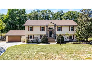 Beautiful home with manicured lawn, brick entry, and spacious two-car garage at 16017 Harbar Oaks Dr, Montverde, FL 34756