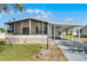 Charming single-story home featuring a carport, screened-in porch, and well-maintained landscaping at 27 Florence Blvd, Debary, FL 32713