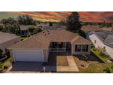 Charming home with a well-manicured lawn and inviting entrance, complemented by a two-car garage and landscaped garden beds at 314 Olanta Dr, The Villages, FL 32162