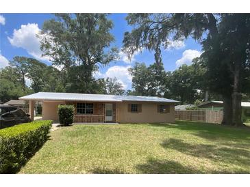 Charming single-story home with a well-maintained lawn and mature trees, offering great curb appeal at 3309 Ne 16Th Ave, Ocala, FL 34479