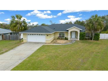 Charming single-story home with well-maintained lawn, two-car garage, and welcoming entrance at 3900 Sw 102Nd Pl, Ocala, FL 34476
