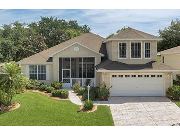 Charming home featuring a well-manicured lawn and inviting front porch at 6122 Sailboat Ave, Tavares, FL 32778