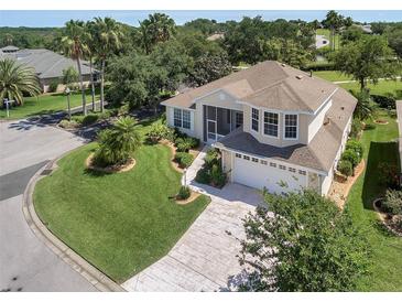 Beautiful two-story home with attached two-car garage and manicured lawn and landscaping at 6122 Sailboat Ave, Tavares, FL 32778