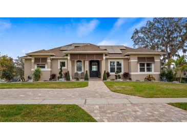 Charming single-story home with a well-manicured lawn and beautiful stone walkway at 11007 Lake Katherine Cir, Clermont, FL 34711