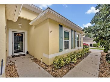 Charming single-Gathering home featuring a welcoming entrance, neat landscaping, and stylish green shutters at 257 Winding Cove Ave, Apopka, FL 32703