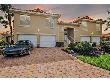 Charming Mediterranean-style townhouse with a brick driveway, two-car garage and well manicured landscaping at 5359 Compass Pt, Oxford, FL 34484