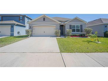 Charming single-story home featuring a well-manicured lawn, neutral paint, and an attached two-car garage at 3719 Holly Grove Ln, Mount Dora, FL 32757