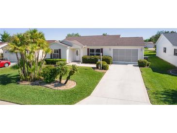 Charming single-story home with well-manicured landscaping and a driveway at 2008 Cipriano Pl, The Villages, FL 32159