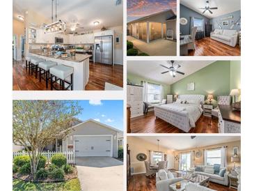 Bright kitchen with stainless appliances, center island, and pendant lighting at 2602 Young Ln, The Villages, FL 32163