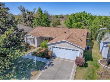 Beautiful single-story home with a well-maintained lawn, two car garage, and a classic, timeless design at 337 Olanta Dr, The Villages, FL 32162