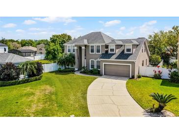 Beautiful two-story home with a well-manicured lawn and a spacious driveway leading to an attached two-car garage at 342 Lake Amberleigh Dr, Winter Garden, FL 34787