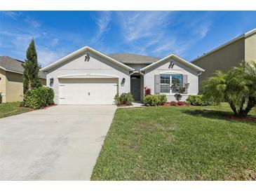 Charming single-story home featuring an attached two-car garage and beautifully landscaped front yard at 3646 Maidencain St, Clermont, FL 34714