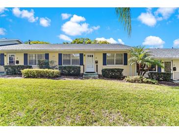 Charming one-story home with manicured lawn, complemented by lush bushes and a vibrant green lawn at 450 Liberty Ave # 3, Mount Dora, FL 32757