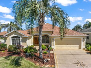 Charming single-story home with well-maintained landscaping and a welcoming two-car garage at 859 Parksville Path, The Villages, FL 32162