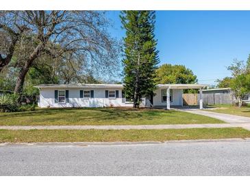 Charming single story home with a well maintained lawn and a carport at 102 S Sunland Dr, Sanford, FL 32773