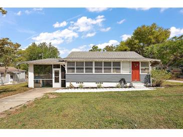 Charming single-story home with a well-manicured lawn and a striking red front door at 952 W Montrose St, Clermont, FL 34711