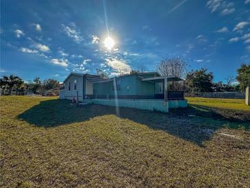 View of the house and yard from the front yard on a sunny day at 103 Caroline Ave, Lady Lake, FL 32159