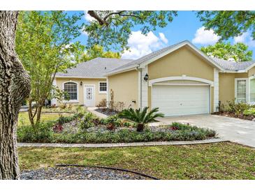Charming home with lush landscaping and a well-maintained lawn at 6152 Topsail Rd, Lady Lake, FL 32159