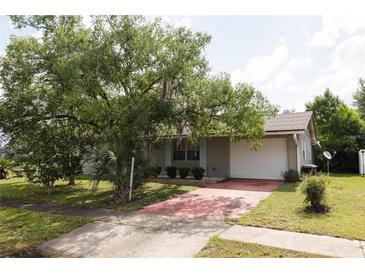 Charming single Gathering home with mature landscaping, light shutters, and a two car garage at 15159 Sw 43Rd Terrace Rd, Ocala, FL 34473