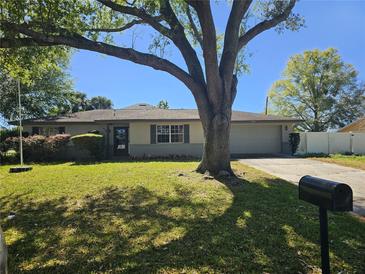 Charming single-story home with a well-maintained lawn and mature tree providing shade at 2181 Gretna Dr, Deltona, FL 32738