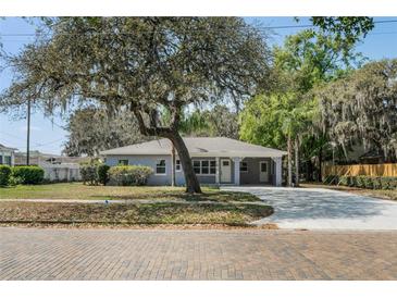 Charming single-story home with covered front porch and mature trees in a desirable neighborhood at 234 S Central Ave, Apopka, FL 32703