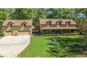 Charming home with a large front yard, three dormer windows, and an attached three-car garage at 39636 Carolina Ave, Lady Lake, FL 32159