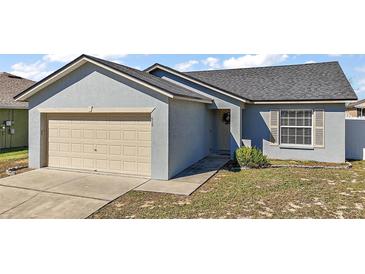 Charming single-Gathering home with a one-car garage and well-maintained front lawn at 638 Sierra Cir, Davenport, FL 33837