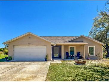 Charming single-story home featuring an attached two-car garage and a well-manicured front lawn at 6679 Cr 613, Bushnell, FL 33513