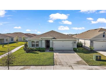 Charming single-story home with well-maintained landscaping and a two-car garage at 2897 Sunridge Loop, St Cloud, FL 34771