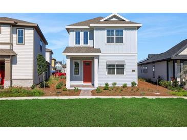 Charming two-story home with a red front door and well-manicured lawn at 6553 Rover Way, St Cloud, FL 34771