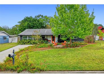 Charming single-story home featuring a lush lawn, beautiful landscaping, and cozy seating area at 375 N Boyd St, Winter Garden, FL 34787