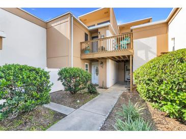 Charming condo featuring a private balcony, well-kept landscaping, and welcoming entryway at 1051 S Highland St # 4B, Mount Dora, FL 32757