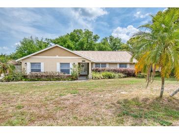 Charming single-story home with a well-manicured lawn and mature landscaping at 11763 Oswalt Rd, Clermont, FL 34711
