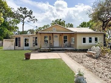 Charming single-story home with a welcoming front porch and landscaped front yard at 1425 Douglas Rd, Groveland, FL 34736