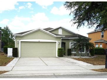 Charming single-story home featuring a two-car garage, well-manicured lawn, and neutral-colored exterior at 146 Essex Pl, Davenport, FL 33896