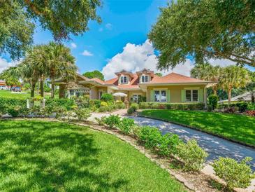 Charming single-Gathering home with manicured lawn, stone accents and beautiful landscaping at 39023 Griffin Lndg, Lady Lake, FL 32159