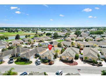 An aerial view of a beautiful single-Gathering home in a lush community with water views, mature landscaping, and serene surroundings at 1536 Barnwell Pl, The Villages, FL 32162