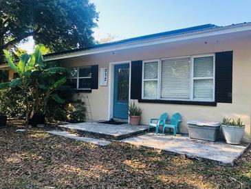 Charming single-story home featuring a cozy front porch and well-maintained landscaping at 312 North Blvd W, Davenport, FL 33837