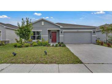 Charming single-story home with a well-manicured lawn and a two-car garage at 4905 Vellacito Way, Davenport, FL 33897