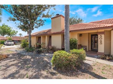 Charming single-story home featuring a tile roof, neutral paint, and well-maintained landscaping at 5045 Maui Cir # 12, Orlando, FL 32808