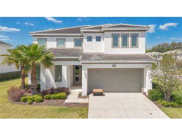 Beautiful two-story home featuring a neutral color palette and well-manicured front yard at 598 Marcello Blvd, Kissimmee, FL 34746
