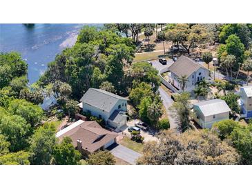 Beautiful aerial view of homes surrounded by lush greenery and a serene lake at 12110 Palmetto Ct, Dunnellon, FL 34432