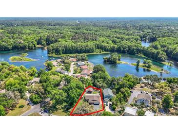 Stunning aerial view of home with lush greenery and beautiful lake views in a desirable neighborhood at 12110 Palmetto Ct, Dunnellon, FL 34432