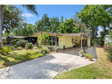 Charming single story home featuring a well manicured lawn, covered entryway, and driveway at 1639 W Schwartz Blvd, The Villages, FL 32159