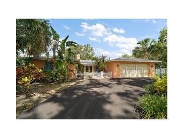 Charming single-story home with a lush front yard and a two-car garage at 2121 Suzanne Dr, Mount Dora, FL 32757