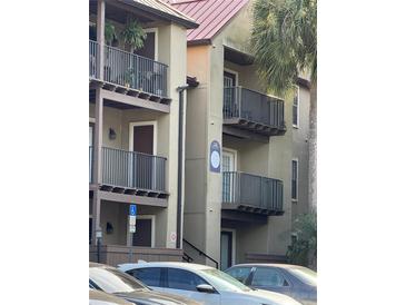 Condominium exterior featuring balconies, neutral paint, and well-maintained landscaping for a welcoming appeal at 236 Afton Sq # 309, Altamonte Springs, FL 32714