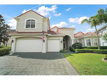 Beautiful two-story home features a tile roof, three-car garage and neatly manicured lawn at 2497 Heritage Green Ave, Davenport, FL 33837