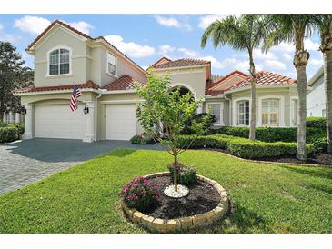 Charming home with well-maintained lawn and decorative landscaping in a desirable neighborhood at 2497 Heritage Green Ave, Davenport, FL 33837