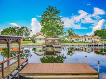 Picturesque waterfront view featuring a private dock at 26619 Bimini Dr, Tavares, FL 32778